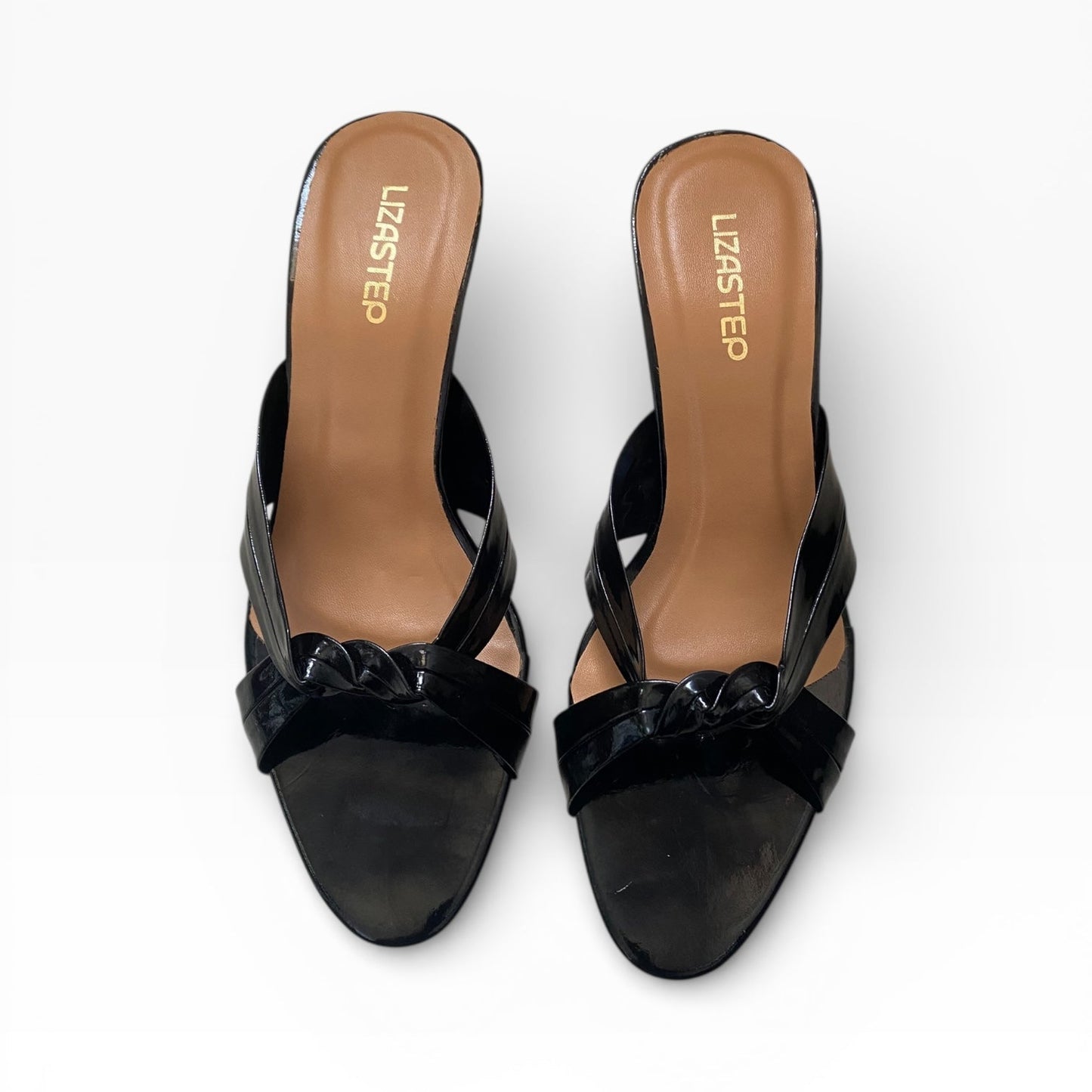 Black high-heeled shoes with a bow detail on a white background