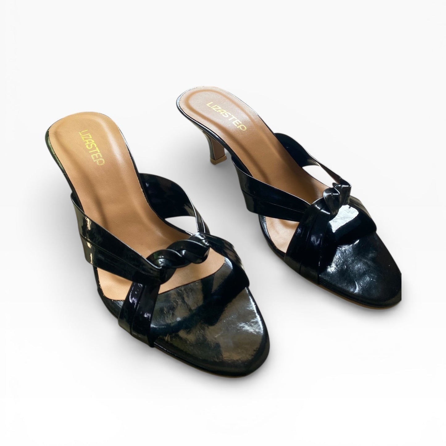 Black high-heeled shoes with a strap on a white background